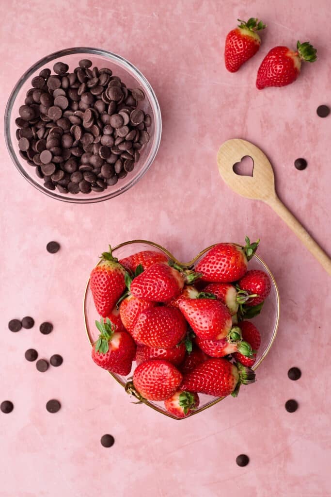 Ingredients to make chocolate covered strawberries - dark chocolate and fresh strawberries.