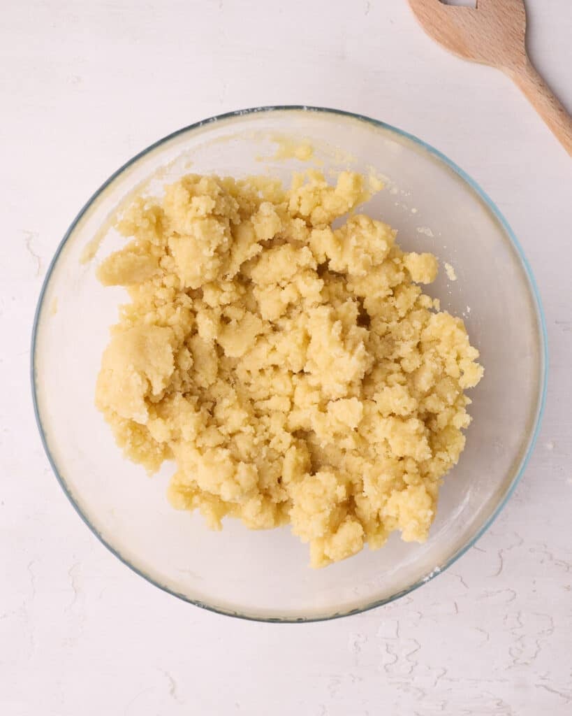 Crumble topping in a glass bowl ready to be used for blueberry crumble. 