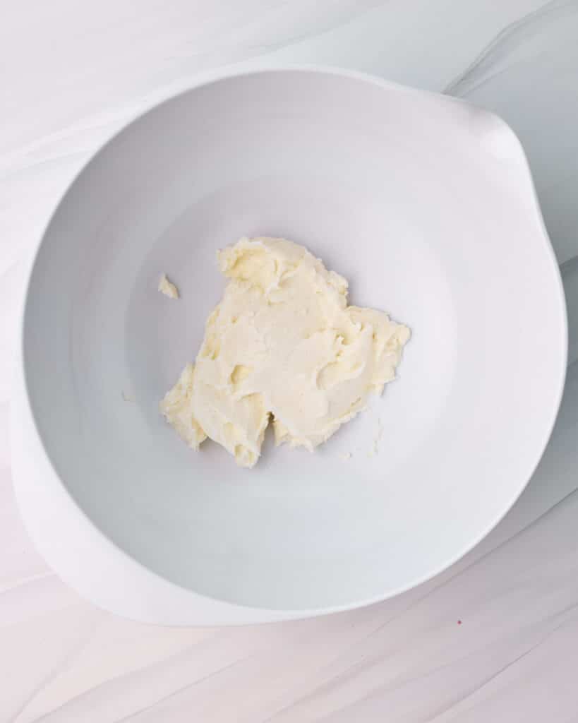 Mascarpone, powdered sugar, and vanilla mixed together in a large bowl.