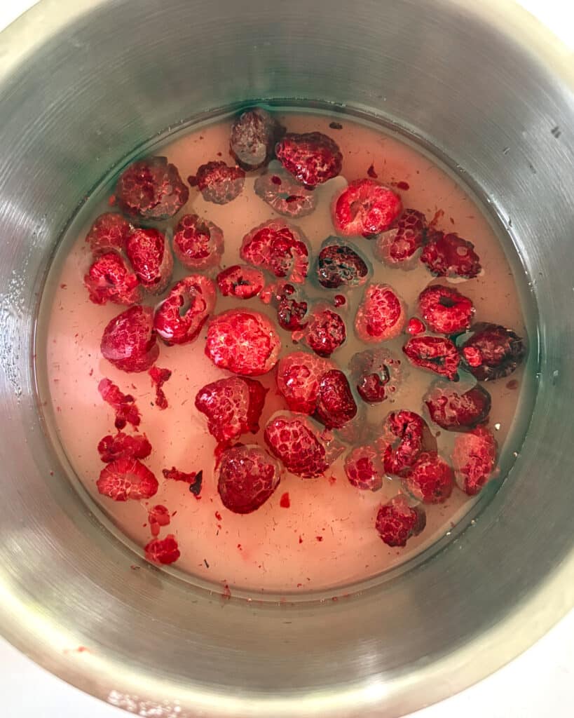 Berries, sugar and water in a saucepan.