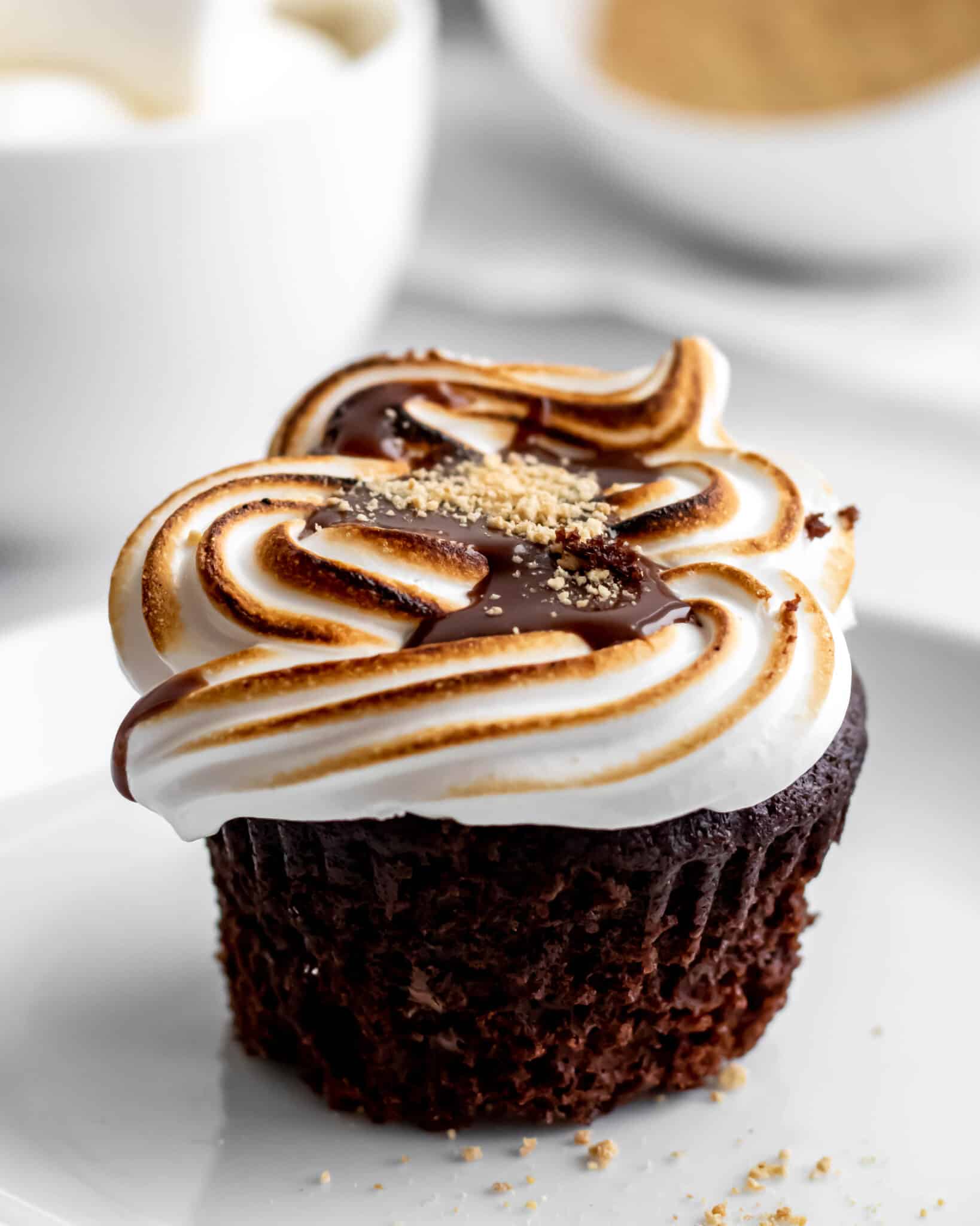 Close up of smores cupcakes with a swirl of toasted marshmallow frosting on top.