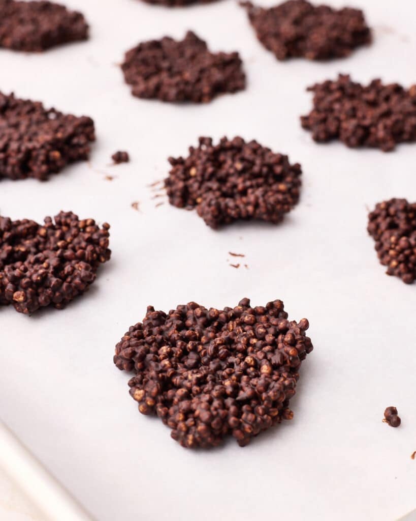 Chocolate quinoa crisps formed on a baking sheet.