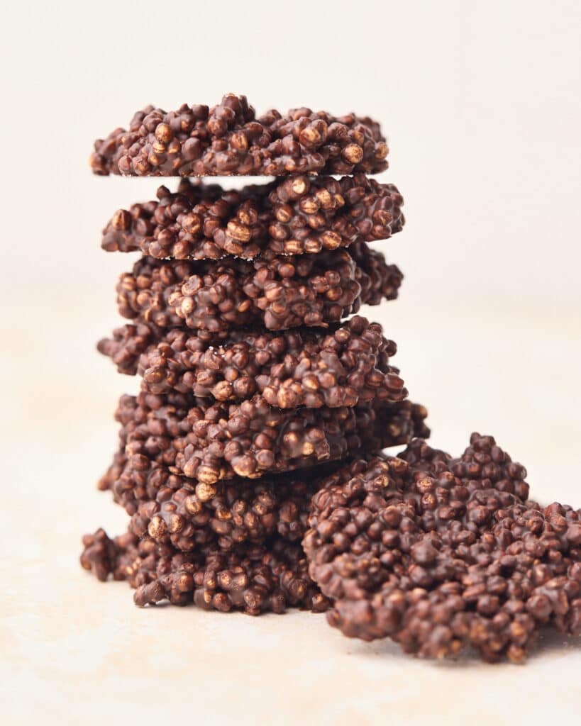 Chocolate quinoa crisps stacked on top of each other after being chilled.
