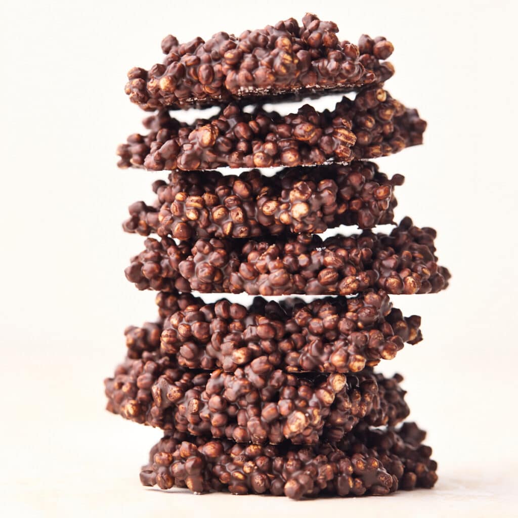 Chocolate quinoa crisps stacked up on top of eachother.