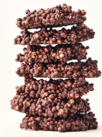 Chocolate quinoa crisps stacked up on top of eachother.