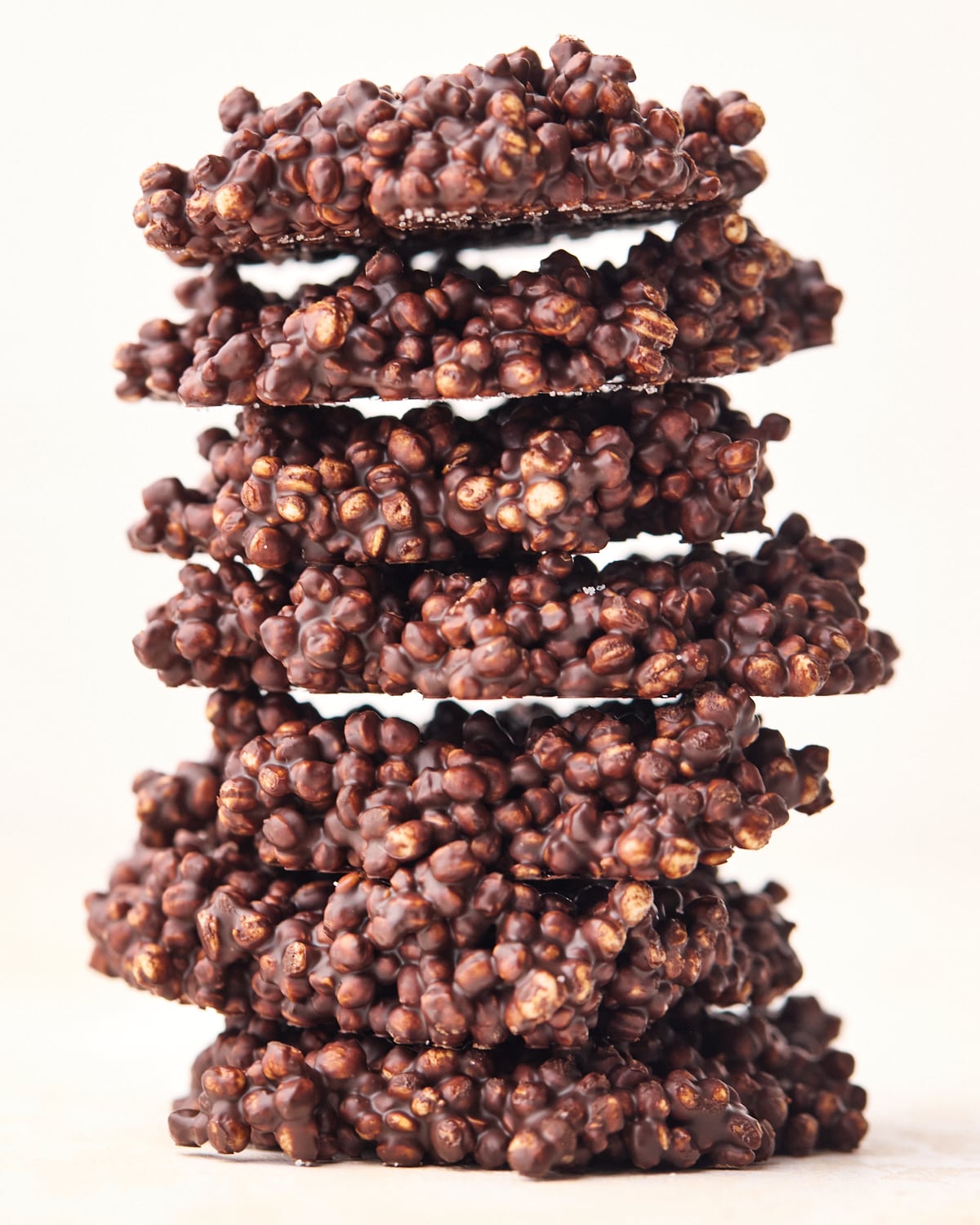 Chocolate quinoa crisps stacked up on top of eachother.