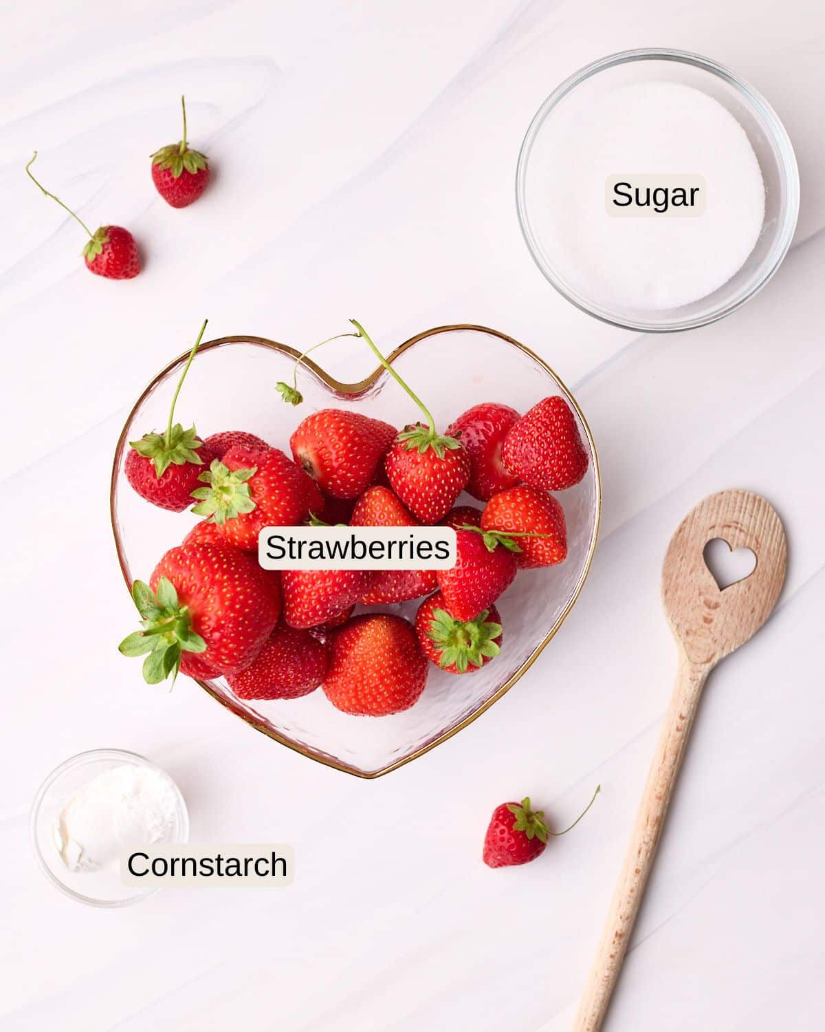 Labelled ingredients for strawberry glaze, including strawberries, sugar, and cornstarch.