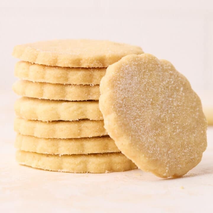 A stack of shortbread cookies, with one leaning on the side of them.