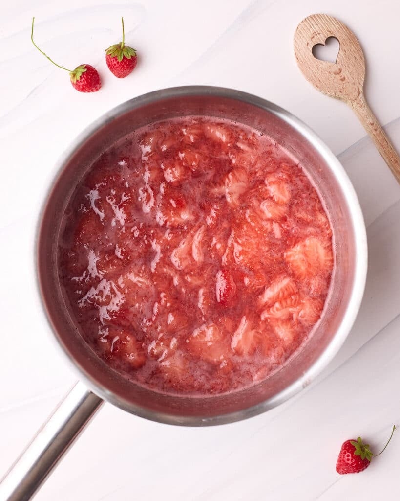 Cornstarch added to saucepan with strawberries and sugar, at a simmering heat so the sugar can dissolve nicely.