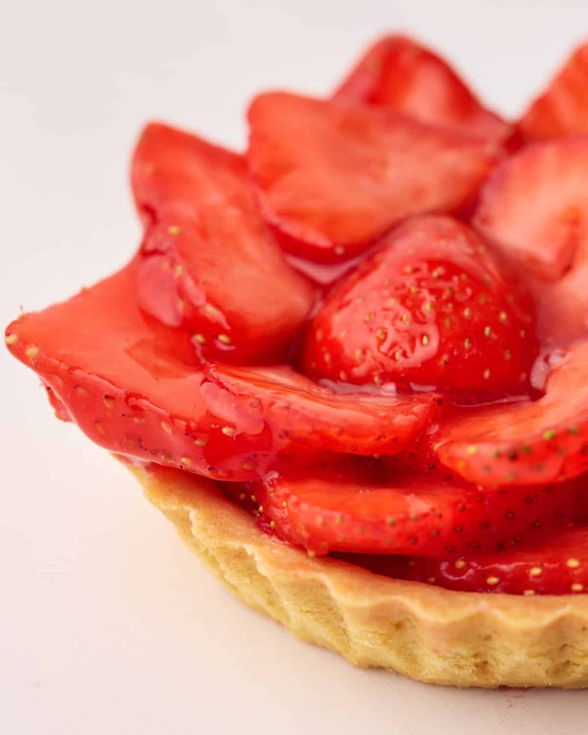 Strawberry tart covered in shiny strawberry glaze.
