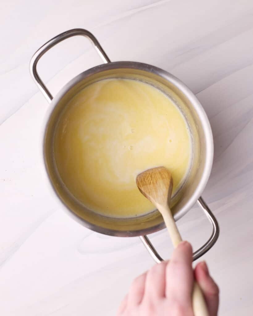 Heating milk and butter in a saucepan to make a hot milk sponge cake.