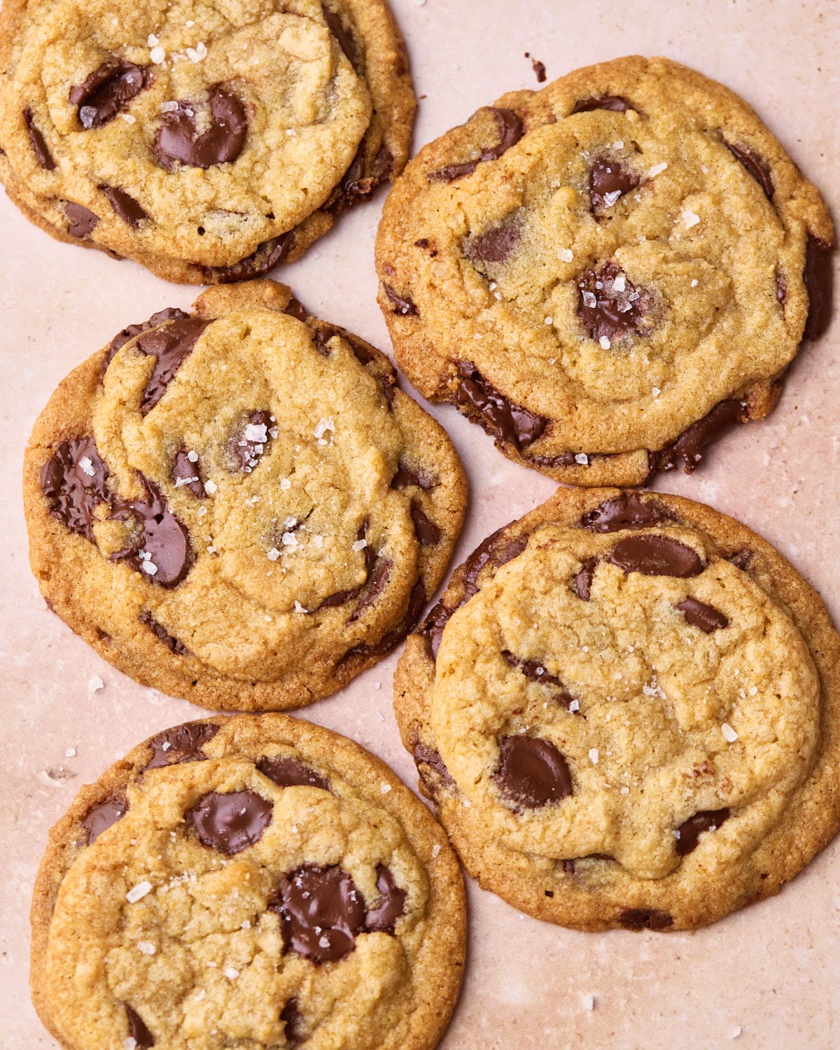 Overhead shot of some chocolate chip cookies, lying next to each other.
