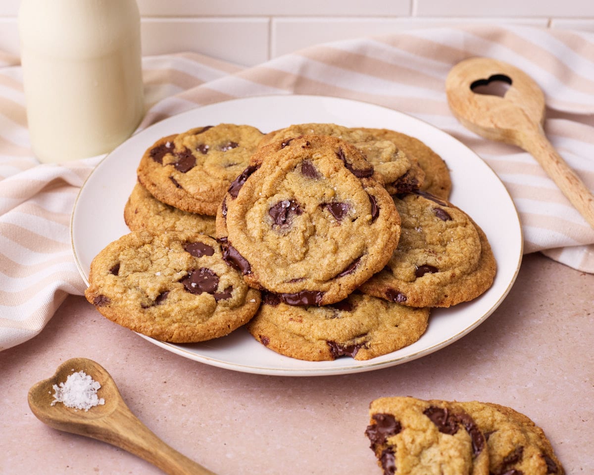 A batch of chocolate chip cookies on a large plate.