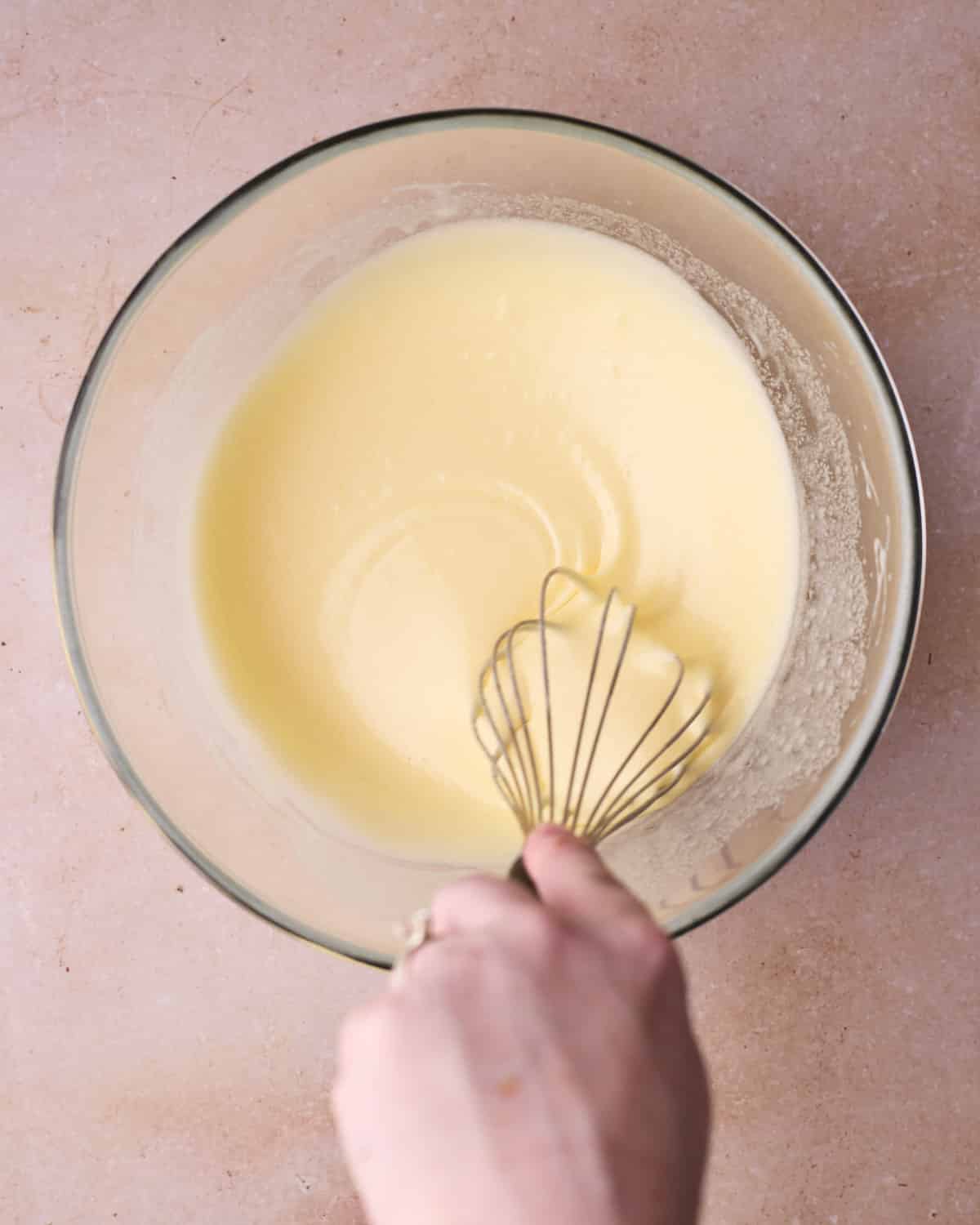 Eggs and sugar being whipped together in a separate bowl.