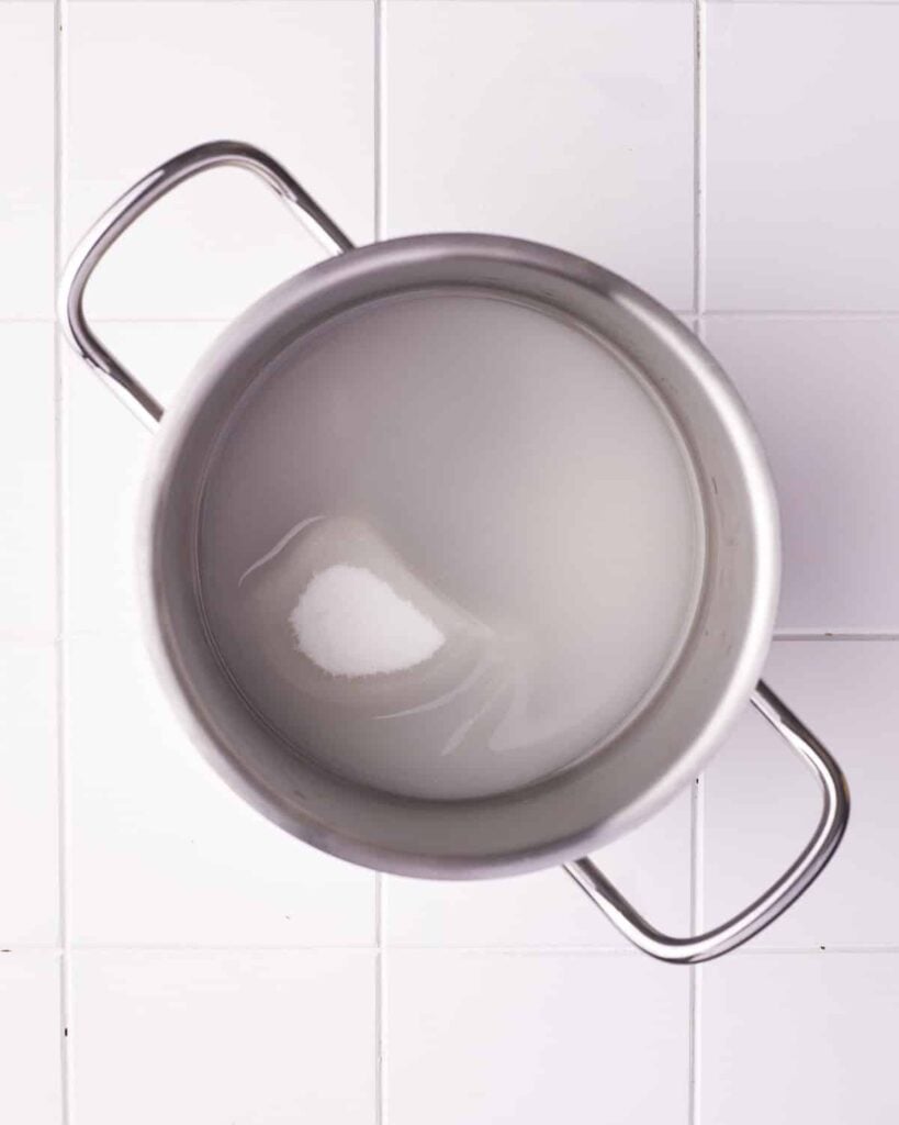Sugar and water in a saucepan.