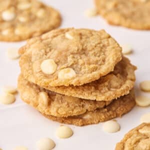 Tower of white chocolate chip cookies stacked on top of each other.