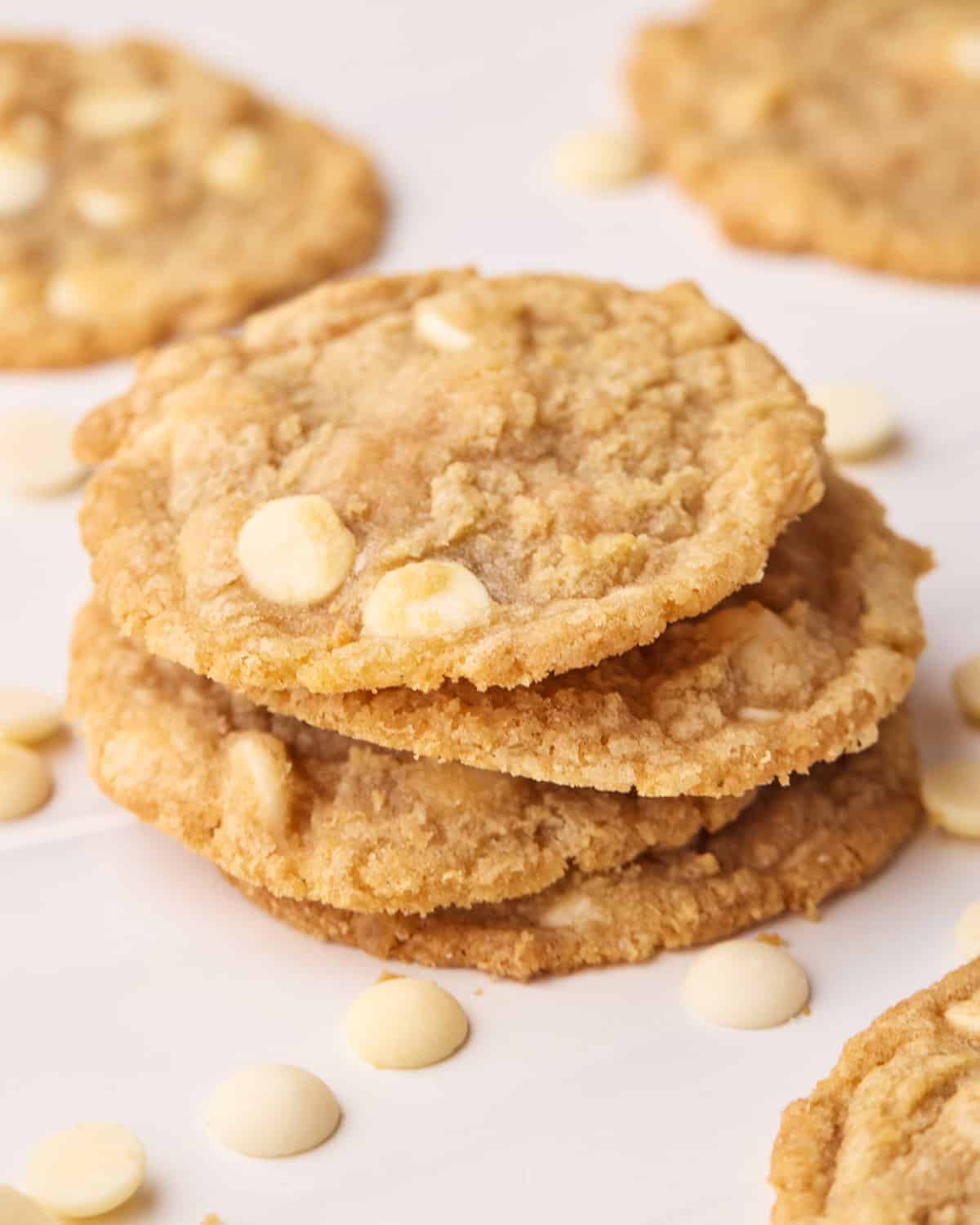 Tower of white chocolate chip cookies stacked on top of each other.