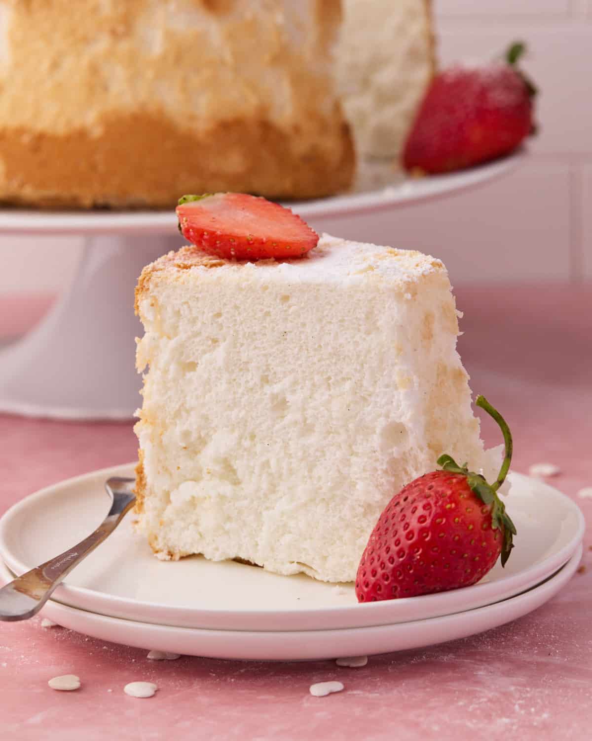 Close up of a slice of angel food cake to show the soft, cloud-like texture.