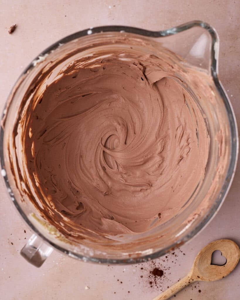 Chocolate whipped cream in a glass mixing bowl.