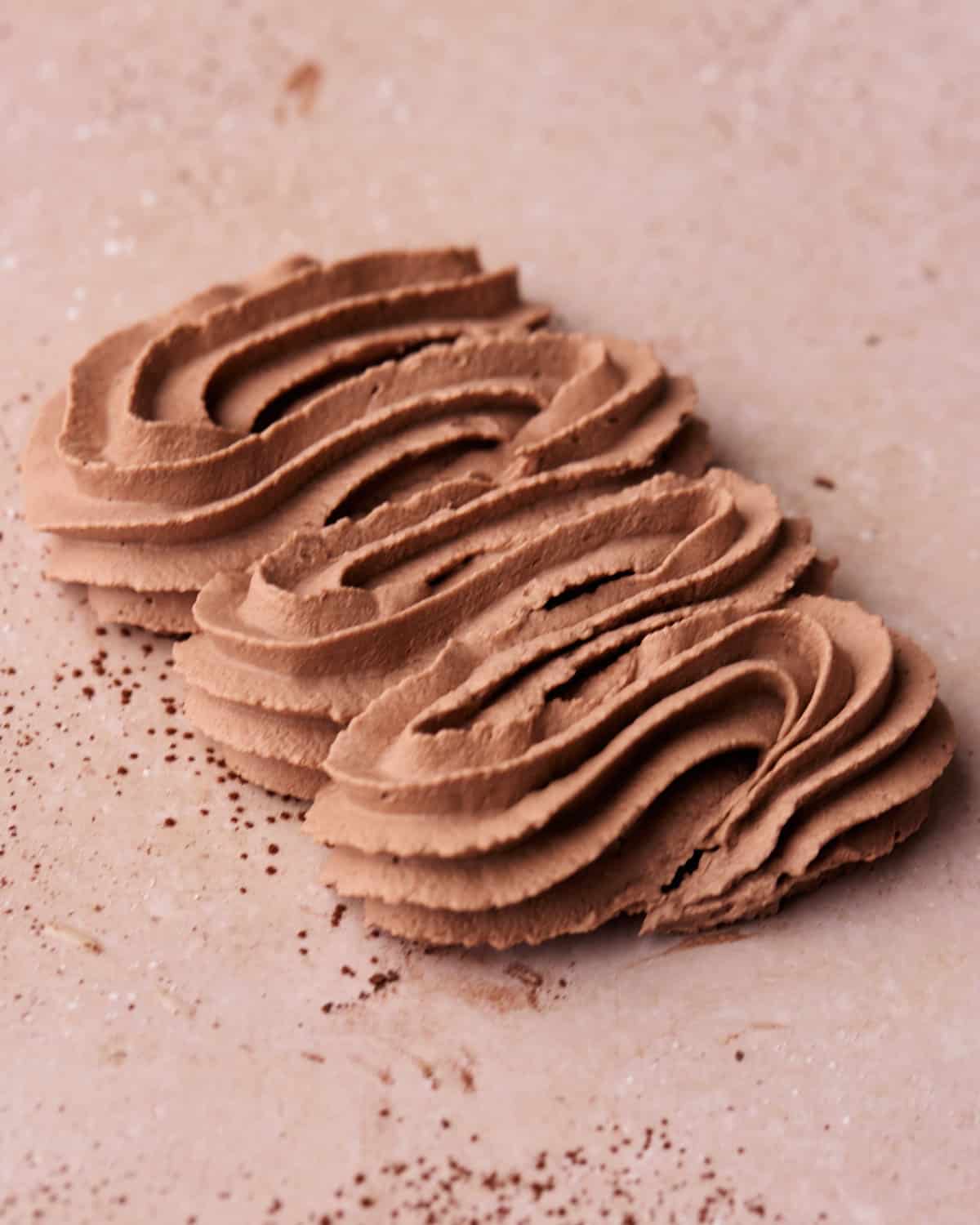 Chocolate whipped cream piped in a zigzag to show the pipeable consistency.