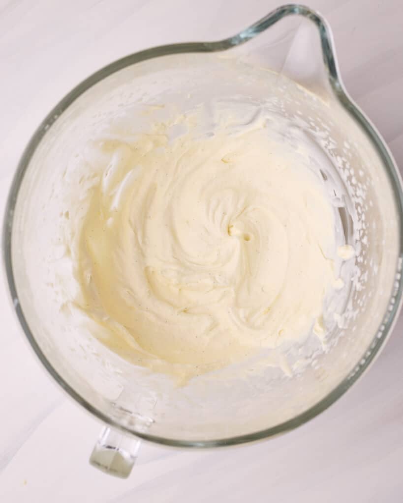 Chantilly cream whipped to soft peaks in a glass mixing bowl.