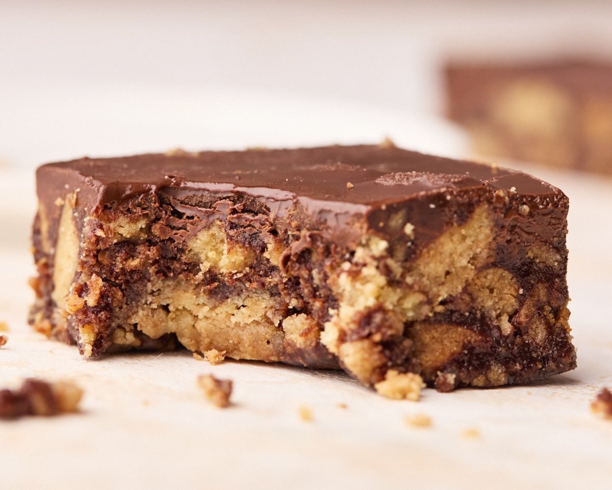 Chocolate tiffin with a bite taken out of it to show the soft but crunchy filling.