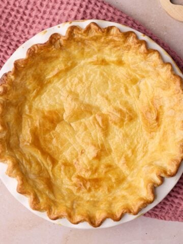 blind baked pie crust with golden brown crimped edges.