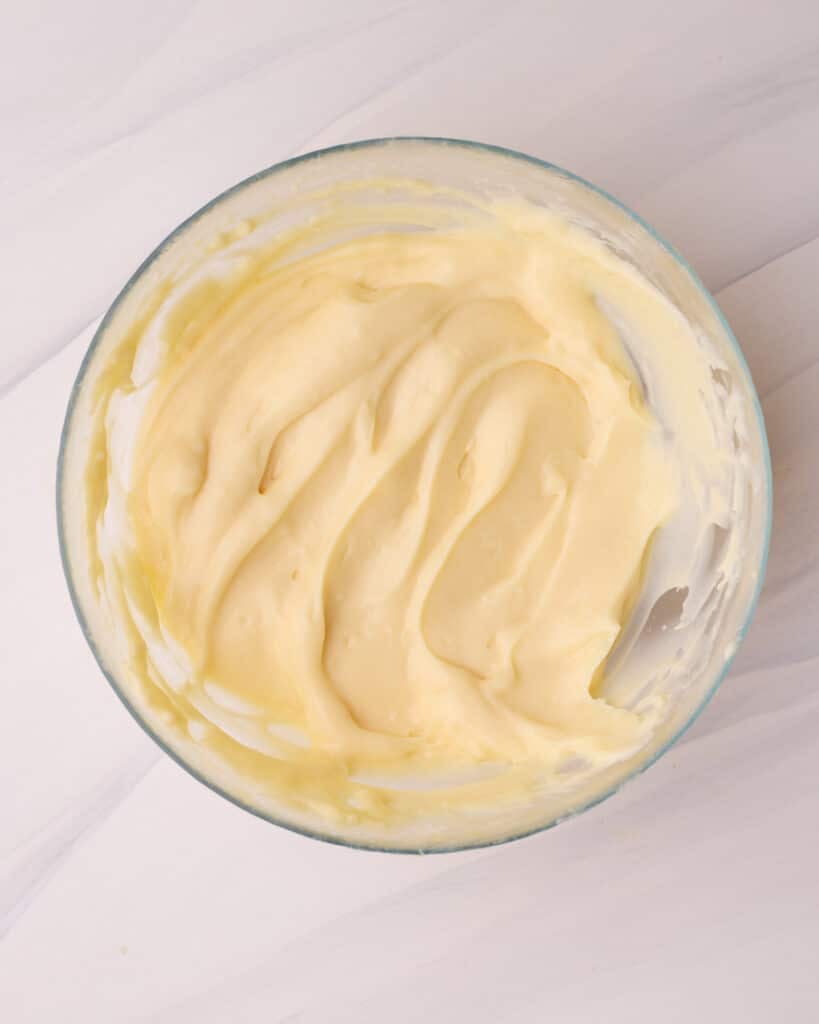 Vanilla pastry cream in a glass bowl, ready to fill a fresh fruit tart.