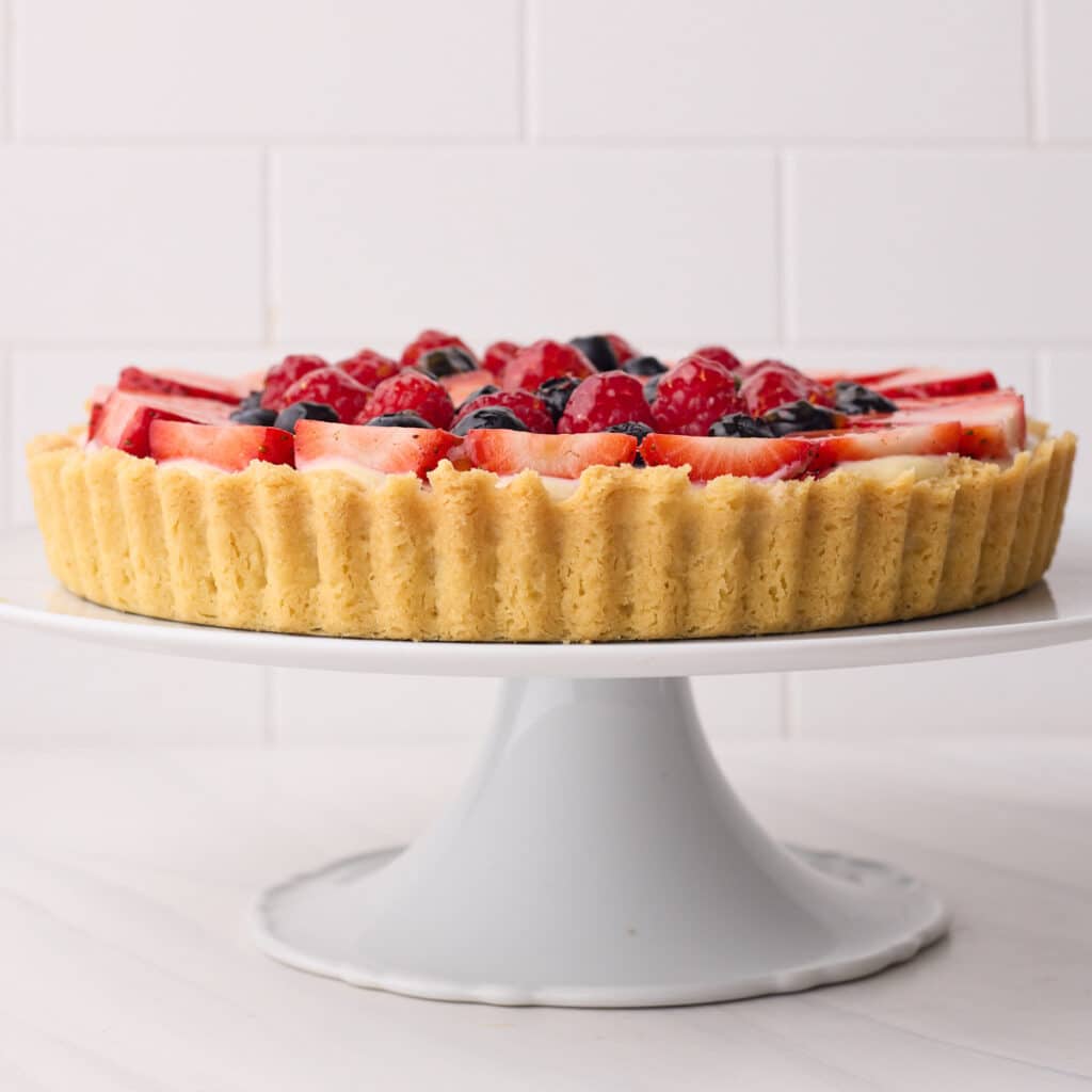 fruit tart from the side to show the shortbread crust (pate sablee).