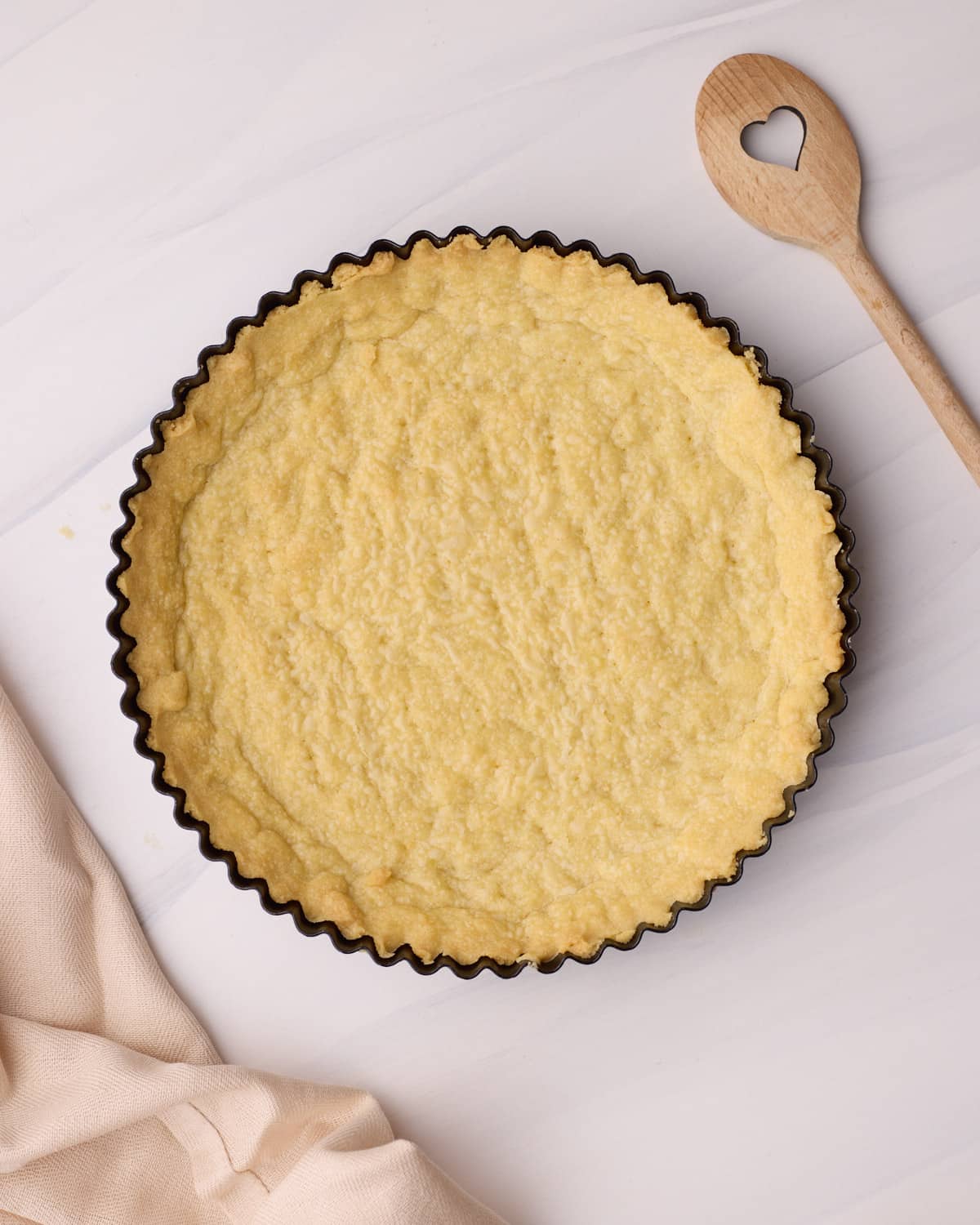 Overhead view of a shortbread tart crust (pate sablee). 