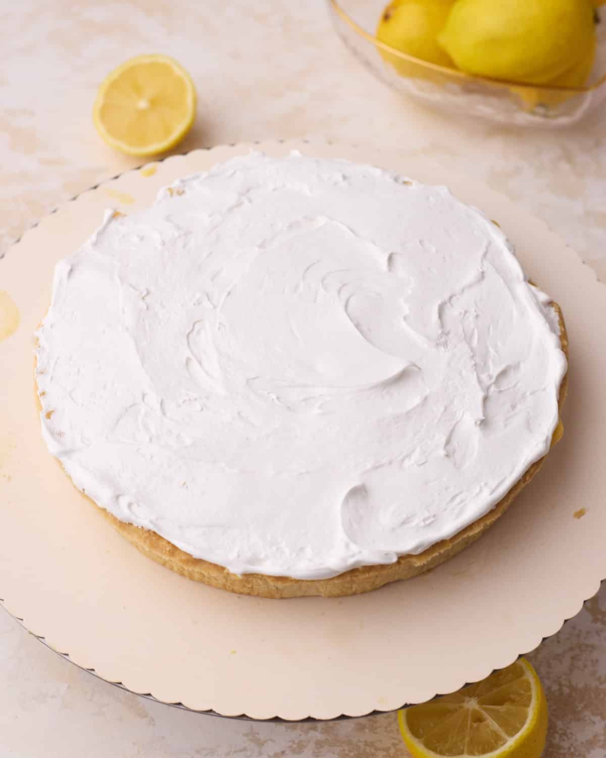 Spreading a thin layer of meringue on top of lemon pie to seal in the filling before adding the rest.