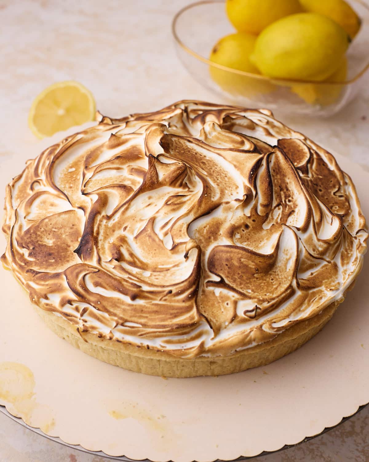 Lemon meringue pie with toasted swiss meringue on top using a kitchen torch.