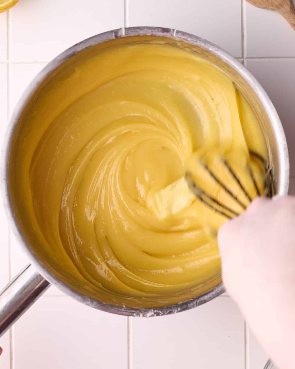 Butter being whisked into lemon filling for lemon meringue pie.