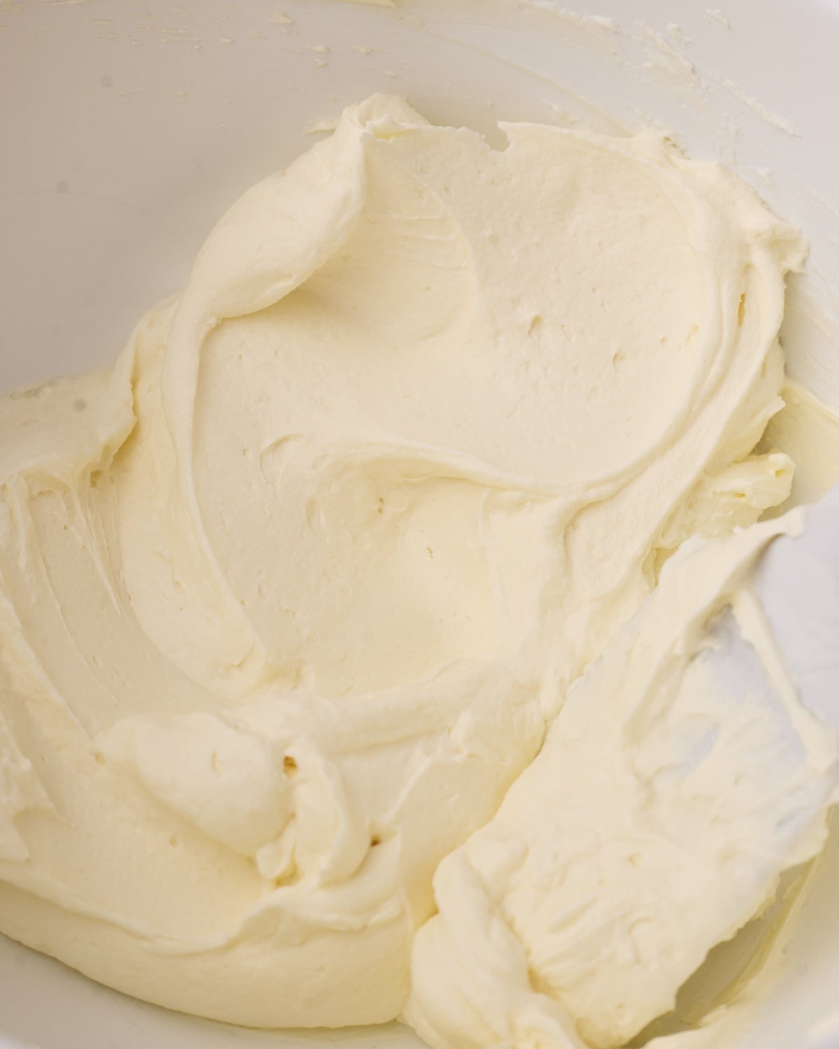 Close up of mascarpone cream in a bowl to show the silky texture.