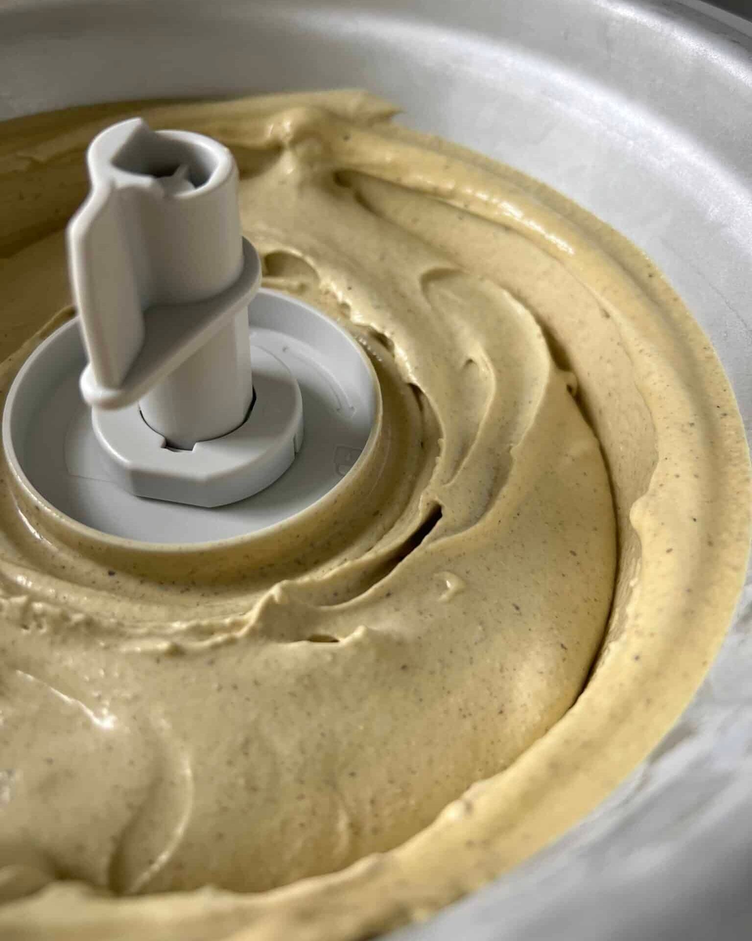 Pistachio ice cream being churned in an ice cream maker.